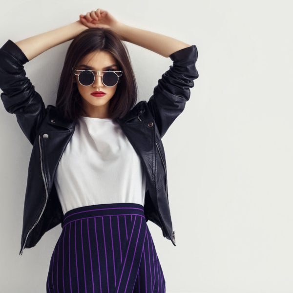 Fashion portrait of a young woman in leather jacket.